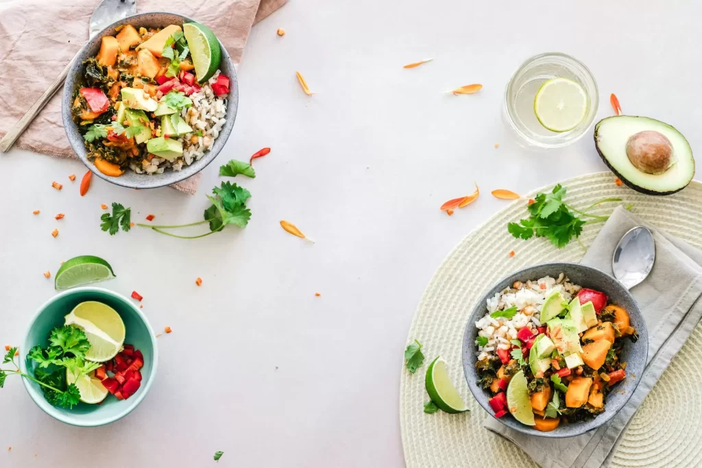 A panoramic view of a table with 3 plates of healthy food on top
